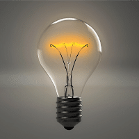 Mirrors with integrated lighting add convenience to public washrooms. a light bulb